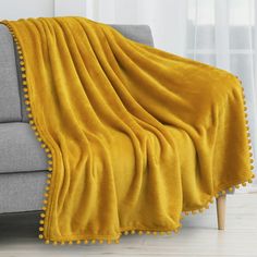 a couch with a yellow blanket on it