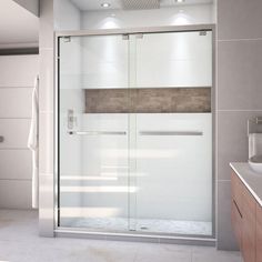 a bathroom with a glass shower door next to a white sink and counter top area