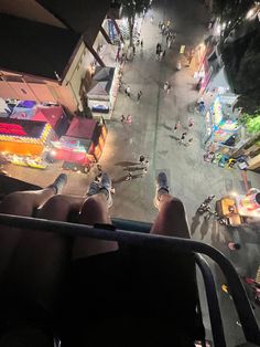 people are sitting on the back of a bus looking down at an open city street