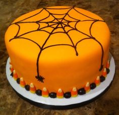 a spider web cake is decorated with candy