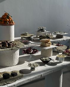 a table topped with lots of different types of cakes and desserts next to each other