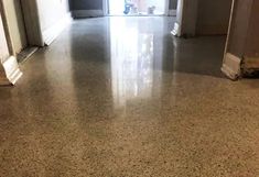 an empty hallway with white walls and flooring is pictured in this image from the front door