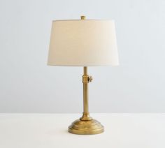 a lamp that is on top of a table with a white light in the background