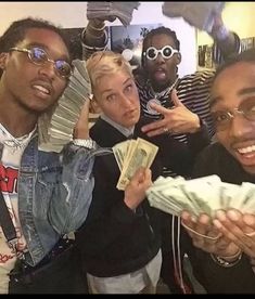 some people are posing for a picture with money in their hands and one person is pointing at the camera