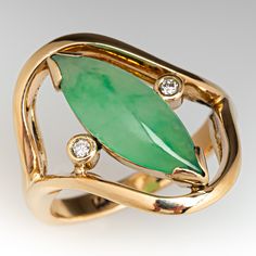 This posh ring is centered with one (1) marquise cabochon cut natural jadeite jade set into a two-prong chevron style setting. The jade is flanked to each side by one (1), bezel set, round brilliant cut diamond. The ring measures 20.0mm at the top, rises 7.1mm above the finger, tapering to 2.6mm wide and 1.1mm thick at the base of the shank. Round Brilliant, Round Brilliant Cut Diamond, Bezel Setting, Stacking Rings, Brilliant Cut Diamond, Jade, Diamond Ring, Gemstone Rings, Jewelry Rings