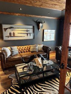 a living room filled with furniture and a cow skull mounted on the wall