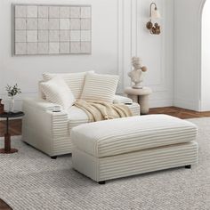 a living room with a white couch and ottoman