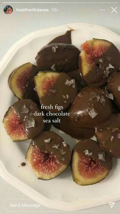 fresh figs with dark chocolate and sea salt on a white plate, ready to be eaten