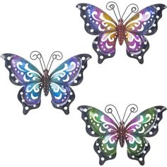 three metal butterflies with different colors and designs on their wings, one is purple, the other is green