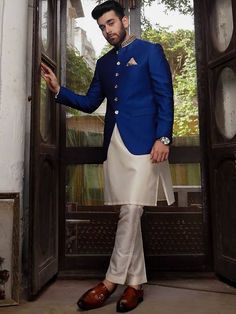 <p>Color: Dark blue<br />Fabric: Raw Silk<br />Stylish prince coat features rich quality embellishments accentuate on the collar<br />Fancy button closure<br />Comes with off-white kurta and pajama</p> <p> </p> <p><strong>Additional Accessories:</strong> </p> <p><strong>Plain Kolhapuri/Saleem Shahi shoes:</strong> US$30 (Made with prince coat material)</p> <p><strong>Note:</strong> Price of all prince coat suits includes only 3 pieces i.e. prince coat, kurta/kameez and shalwar/pajama (or whateve Long Sleeve Single Breasted Wedding Sets, Long Sleeve Sets With Button Closure For Wedding, Long Sleeve Wedding Set With Button Closure, Wedding Set With Button Closure And Long Sleeves, Traditional Blue Sherwani For Semi-formal Occasions, Blue Traditional Sherwani For Semi-formal Occasions, Festive Formal Outerwear With Buttons, Semi-formal Blue Zari Work Sets, Royal Festive Wedding Kurta