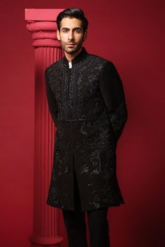 Black bandhgala with embroidered geometric and floral motifs on front. Paired with a white cotton shirt and a black plain trouser. - Aza Fashions Ceremonial Black Sherwani With Cutdana, Black Sherwani With Cutdana For Formal Occasions, Black Bandhgala With Chikankari Embroidery For Transitional Season, Elegant Black Bandhgala With Chikankari Embroidery, Formal Black Bandhgala With Cutdana, Elegant Black Nehru Jacket With Chikankari Embroidery, Fitted Black Bandhgala With Cutdana, Elegant Black Traditional Semi-formal Wear, Elegant Black Semi-formal Traditional Wear