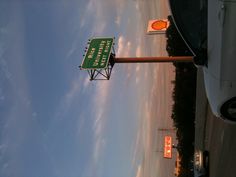 there is a sign that says rice university next to a highway with cars on it