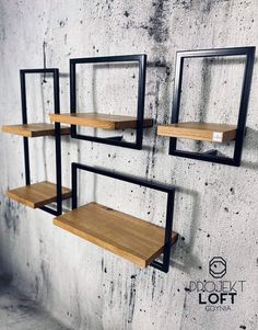 three metal and wood shelves against a concrete wall