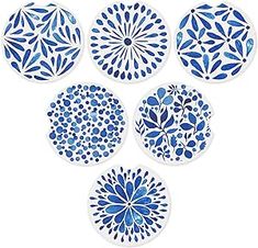 six blue and white plates sitting on top of each other in the shape of flowers