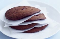 three chocolate cookies are stacked on top of each other