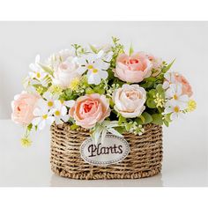 a basket filled with pink and white flowers