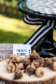 an image of chocolate chip cookies on a wooden tray with a sign that says chocolate acorns