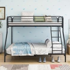 a black metal bunk bed sitting on top of a hard wood floor next to a white dresser