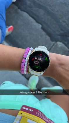 a close up of a person's wrist with a watch and bracelets on it