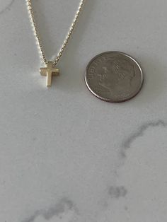 Ensure lasting memories for the special moments in your life with this 14K gold tiny cross necklace, a religious jewelry gift. Crafted for women of Christian faith, this small cross pendant is bold and designed in a 3D mini cross configuration. Free shipping offered. This piece is beautiful, elegant, shiny, and suitably sturdy for a baptismal gift. ⁙ Materials: 14K Yellow Gold⁙ Dimensions: 8MM Height by 6MM Width in diameter, the chain is very sturdy and 1MM wide, it is 16"-18" it can be hooked Dainty 14k Gold Cross Necklace As A Gift, Dainty Cross Pendant Necklace For Gift, Dainty 14k Gold Cross Necklace Gift, Minimalist Cross Pendant Jewelry Gift, Dainty Gold-plated Cross Necklace Gift, Tiny Cross Necklace, Tiny Cross, Cross Gift, Small Crosses