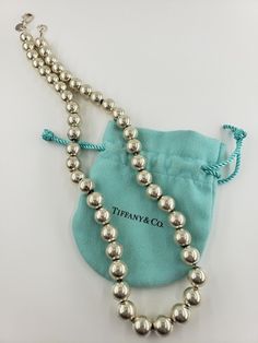 Authentic Tiffany & .Co Vintage 20.5 Inch Ball Bead Necklace With Lobster Clasp Tiffany & Co. Gift bag is included with necklace. BRAND Tiffany & .Co METAL Sterling Silver LENGTH 20.5 Inches Long WEIGHT 199g WIDTH .39 inch (10mm) CONDITION A pre-owned item in very good condition with no damages. ITEM NO #3521 RETURNS Yes, we accept returns with no restocking fees and no questions asked. It is okay to change your mind.Sterling Silver Necklace. Tiffany And Co Necklace, It Is Okay, Vintage Tiffany, Ball Necklace, Real Vintage, Tiffany And Co, Fine Jewellery Necklace, Sterling Silver Necklace, Bead Necklace