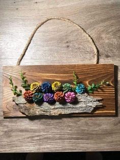 a wooden sign that has flowers on it