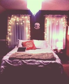 a bedroom with lights on the walls and a bed