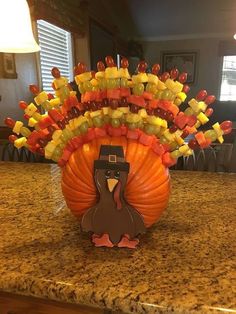 a turkey made out of candy sitting on top of a counter next to a lamp