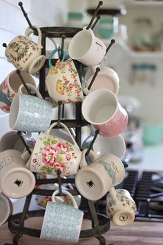 a rack with cups and mugs on it