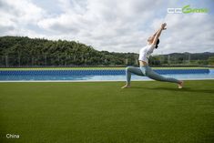 a woman doing yoga in front of a swimming pool