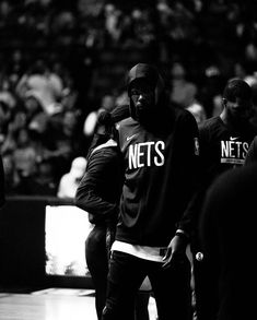 the nets players are walking around in black and white, with one man holding his head