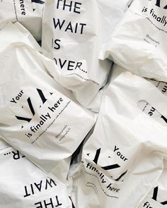 many white bags with black lettering on them