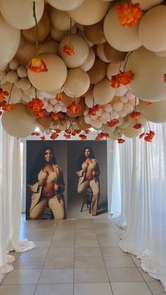 balloons are hanging from the ceiling in front of a large portrait of a naked woman