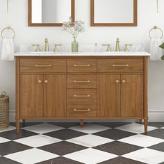 a bathroom vanity with two mirrors above it and a checkered floor in the background