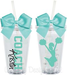 two tumblers with bows and cheerleaders on them