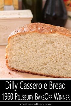 a loaf of casserole bread sitting on top of a counter next to a bottle of wine