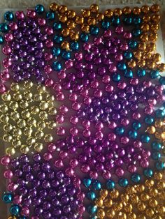 several different colors of beads on a table