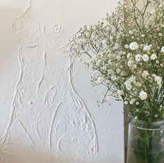 a vase filled with white flowers on top of a table