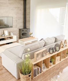 a living room filled with furniture and a fire place in the middle of the room