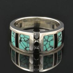 "Spiderweb turquoise ring with black onyx and black diamond accents designed by Mark Hileman. This woman's handmade band features 3 channel set round black diamonds flanked by alternating black onyx and spiderweb turquoise inlay. The 3 black diamonds weigh a total of .18 carats. The ring is 8.5mm wide at the widest point and will be made to order in your size in 3 to 6 weeks. This band is available in other color combinations and in 14k gold or stainless steel for an additional charge. It is han Multi-stone Diamond Jewelry With Round Stones, Turquoise Multi-stone Round Jewelry, Luxury Multi-stone Turquoise Round Ring, Fine Jewelry With Inlay For Anniversary, Luxury Turquoise Multi-stone Jewelry, Luxury Turquoise Anniversary Ring, Modern Turquoise Sterling Silver Jewelry, Luxury Jewelry With Multi-stone Round Shape, Luxury Silver Jewelry With Three Stone Detail