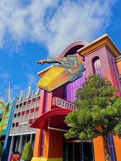 the building is brightly colored and has a large sign on it