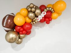 a bunch of balloons are arranged in the shape of a football and balloon garlands