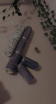 two rolled up newspapers sitting on top of a table next to a flower pot