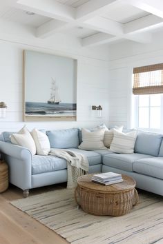 a living room with blue couches and white walls