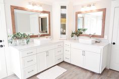 a large bathroom with two sinks and mirrors