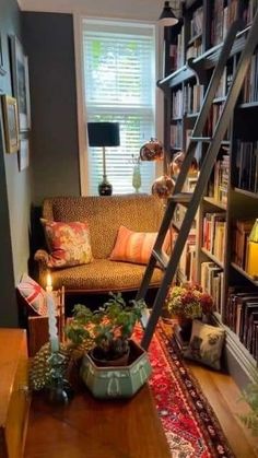 a living room filled with lots of furniture and bookshelves next to a window