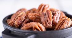 a bowl filled with nuts sitting on top of a table