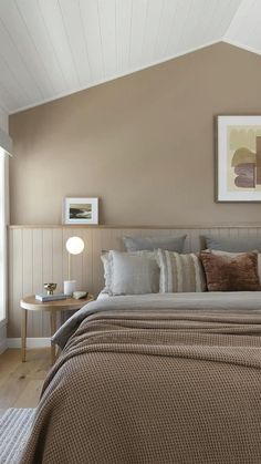 a large bed sitting under a window next to a wooden headboard and foot board