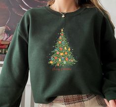 "Womens Christmas Sweatshirt, Christmas Sweater, Christmas Crewneck, Christmas Tree Sweatshirt, Holiday Sweaters for Women, Winter Sweatshirt Unisex Crewneck Sweatshirt. Loose fit for a comfortable feel. FABRICATION * 50% cotton, 50% polyester * Runs true to size SIZING This style is a Unisex Sweatshirt. If you are unsure about the size and the color you should order, please refer to the size and color chart in the pictures. CARE INSTRUCTIONS * Machine wash: warm (max 40C or 105F) * Tumble dry: Green Winter Sweatshirt For Gift, Green Winter Sweatshirt For Gifts, Green Winter Sweatshirt Gift, Green Winter Sweatshirt As Gift, Green Christmas Crew Neck Sweatshirt, Sweaters For Women Winter, Holiday Sweaters, Womens Christmas, Christmas Crewneck