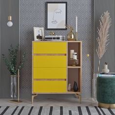 a living room with a yellow cabinet next to a black and white striped wallpaper